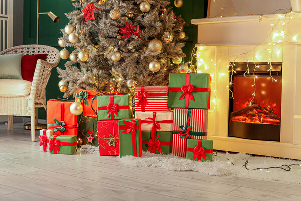 Many gift boxes under Christmas tree in living room