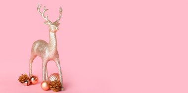 Pembe arka planda Noel dekoru olan ve metin için alanı olan ren geyiği