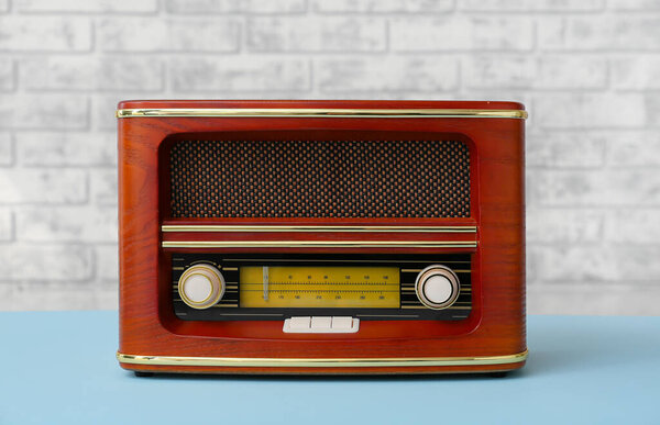 Vintage radio receiver on table in room