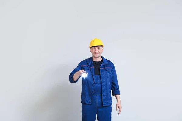 Mature Worker Hardhat Flashlight Light Background — Stock Photo, Image