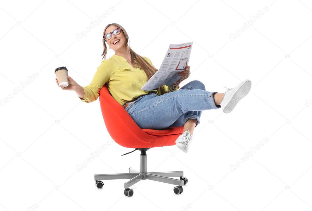 Happy young woman with newspaper and cup of coffee sitting in chair on white background