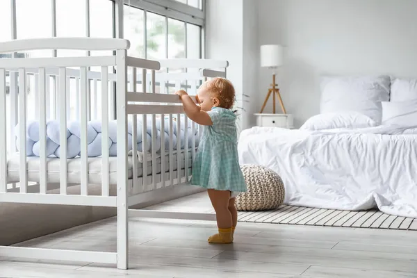可爱的女婴在卧室的婴儿床边学习走路 — 图库照片