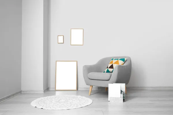 Blank Frames Grey Armchair Light Wall — Stock Photo, Image