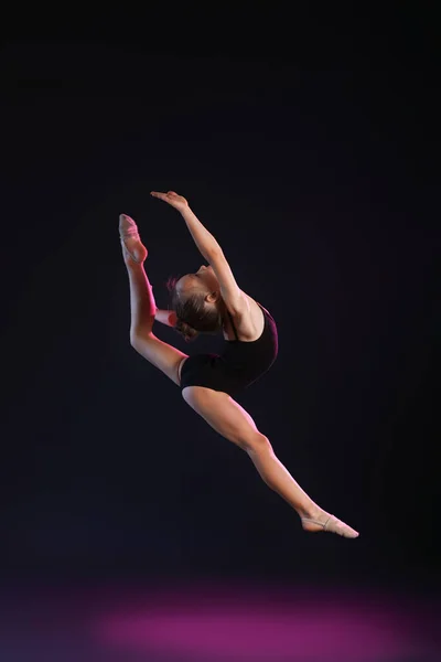 Klein Meisje Doet Gymnastiek Donkere Achtergrond — Stockfoto