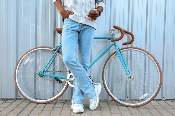 African American Teenage Boy Bike Using Mobile Phone Blue Fence — Stock Photo, Image