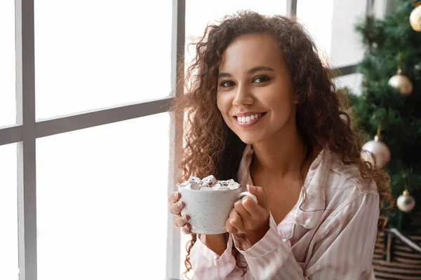 Young African American Woman Cup Hot Cocoa Marshmallows Window Christmas — Stock Photo, Image