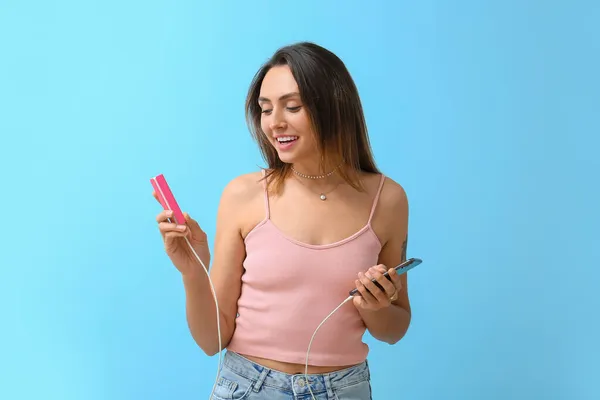 Young Woman Phone Power Bank Color Background — Stock Photo, Image