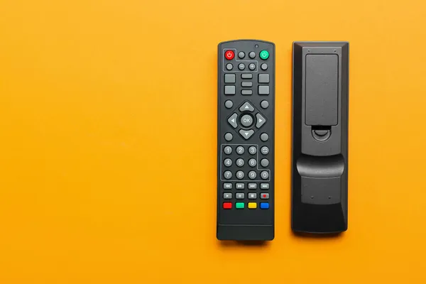 Modern Remote Controllers Orange Background — Stock Photo, Image