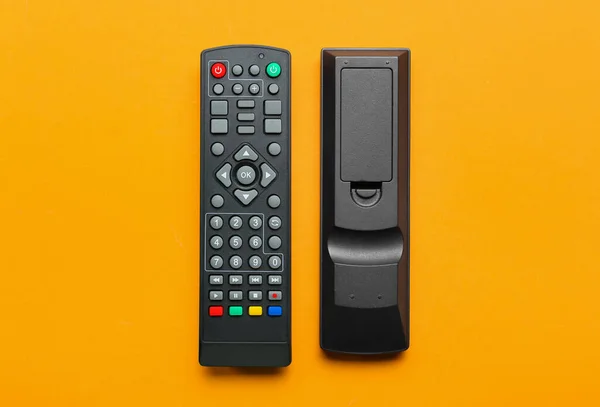 Modern Remote Controllers Orange Background — Stock Photo, Image