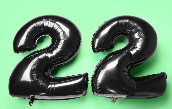 Black Figure Made Balloons Green Background — Stock Photo, Image