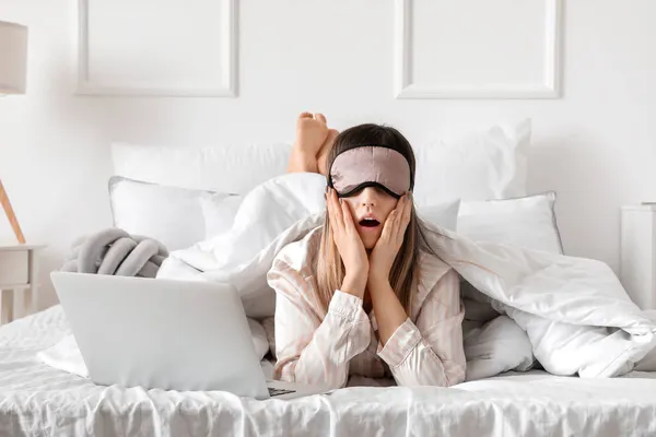 Shocked Woman Sleeping Mask Laptop Lying Bed — Stock Photo, Image