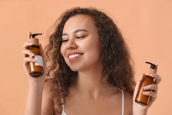 Vacker Afroamerikansk Kvinna Med Kosmetiska Produkter Flaskor Färg Bakgrund — Stockfoto