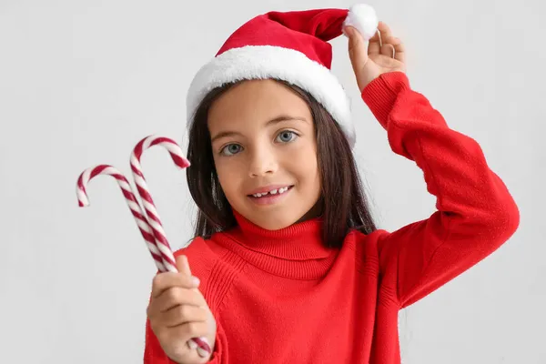 Cute Little Girl Santa Hat Candy Canes Light Background — Stock Photo, Image