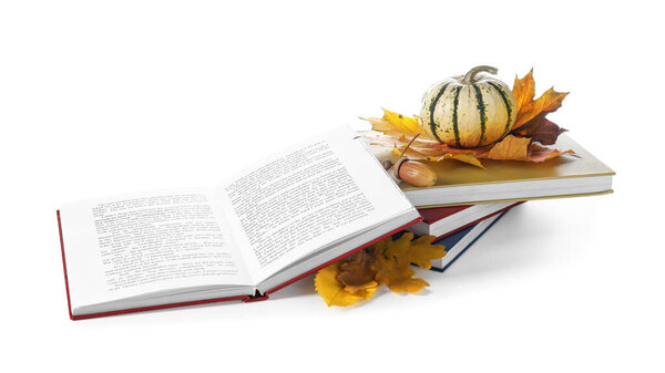 Books, autumn leaves and pumpkin on white background