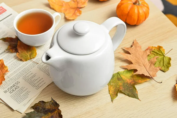 Tea Pot Cup Hot Beverage Newspaper Autumn Leaves Wooden Background — Stock Photo, Image