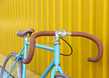 Sarı duvarın yanında modern mavi bisiklet