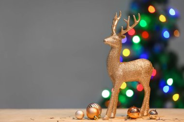 Altın ren geyiği ve Noel topları bulanık arka planda
