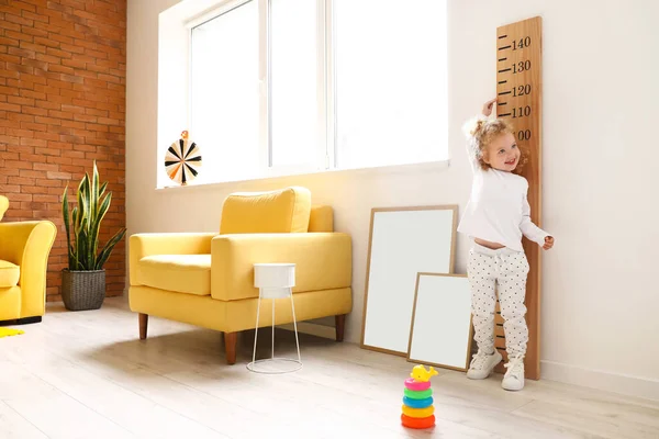 Cute Baby Girl Measuring Height Home — Stock Photo, Image