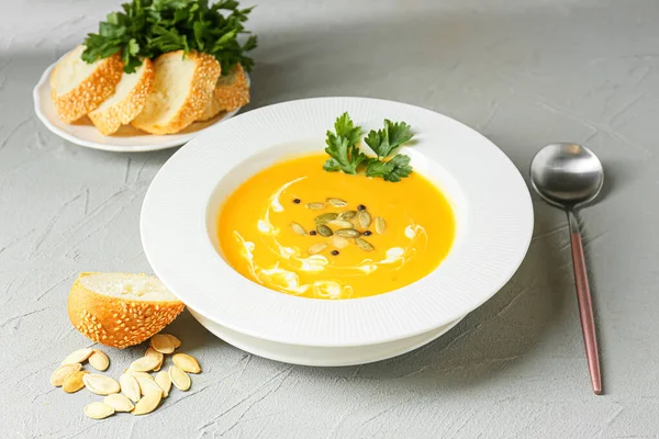 Lezzetli balkabağı kremalı çorba ve hafif arkaplanlı tohumlar.