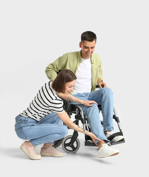 Young Woman Her Husband Having Problem Wheelchair Light Background — Stock Photo, Image