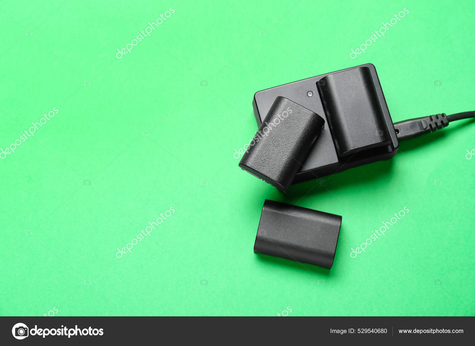 Camera Batteries Charger Green Background Stock Photo by ©serezniy 529540680