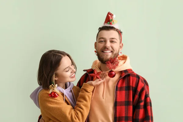 Šťastný Mladý Pár Stylovém Zimním Oblečení Vánoční Výzdobou Světlém Pozadí — Stock fotografie