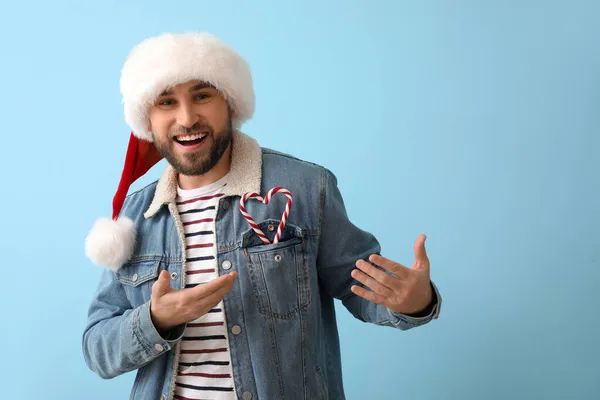 Handsome Man Santa Hat Candy Canes Blue Background — Stock Photo, Image