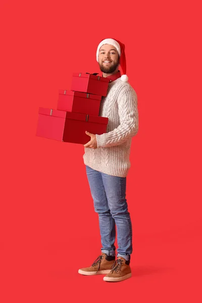 Schöner Mann Mit Weihnachtsgeschenken Auf Farbigem Hintergrund — Stockfoto