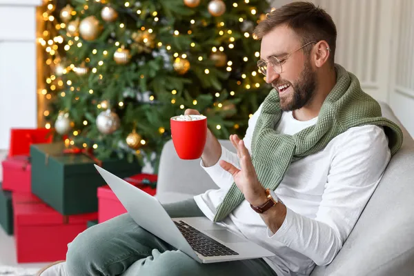 Young man during Christmas online party at home
