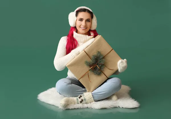Beautiful Woman Earmuffs Big Christmas Gift Green Background — Stock Photo, Image