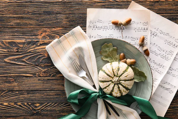 Ahşap zemin üzerinde beste, müzik notaları ve sonbahar dekoru