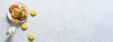 Hanuka kutlaması için lezzetli kurabiyeler ve patates krepleri. Gri arka planda mesaj için yer var.