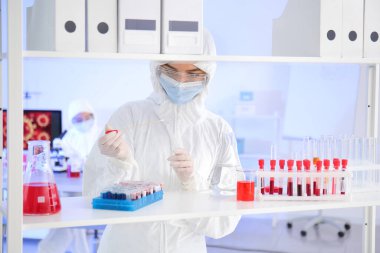 Laboratuvarda numunelerle çalışan bir bilim adamı