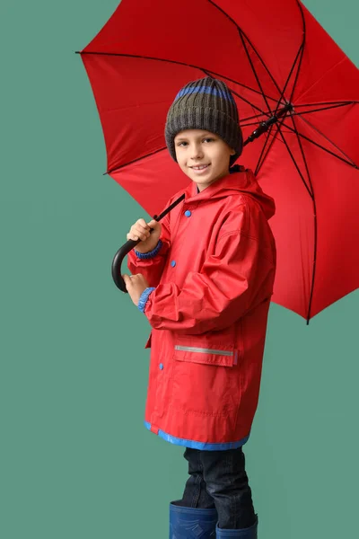Yağmurluk Giymiş Arka Planda Şemsiyesi Olan Küçük Bir Çocuk — Stok fotoğraf