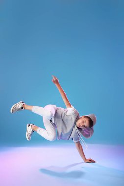 Renkli arka planda dans eden küçük çocuk