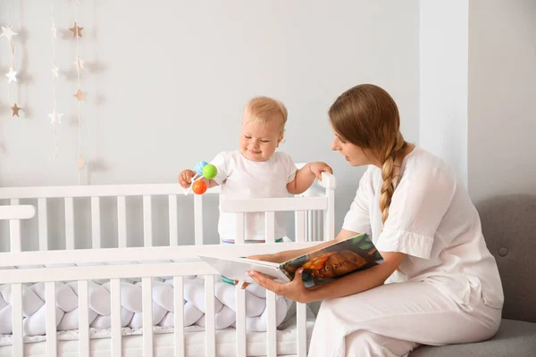 Mother Reading Book Her Cute Little Baby Crib — Stock Photo, Image