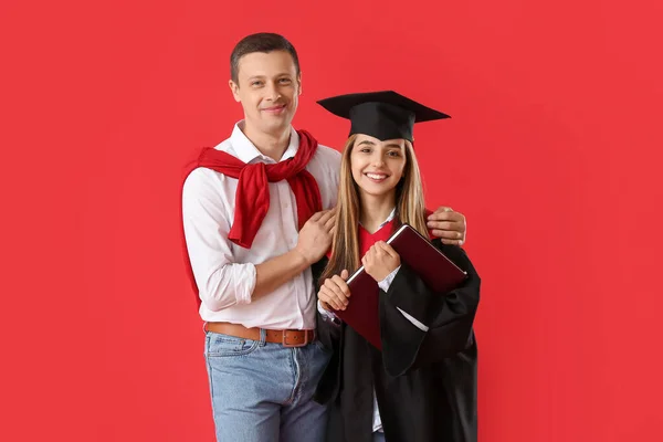 Happy Female Graduation Student Her Father Color Background — Stock Photo, Image