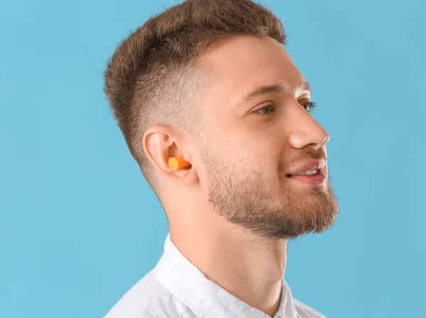 Young Man Ear Plug Blue Background — Stock Photo, Image