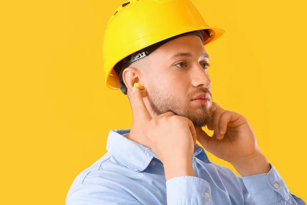 Young Man Hardhat Ear Plugs Yellow Background — Stock Photo, Image
