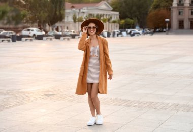 Güneşli bir günde genç ve şık bir kadın.