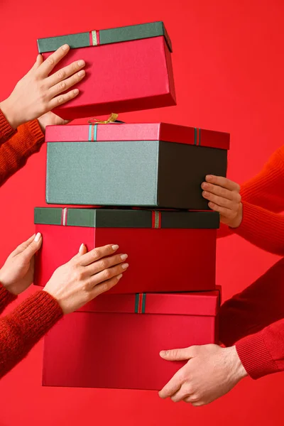 Women Holding Stack Gift Boxes Color Background — Stock Photo, Image
