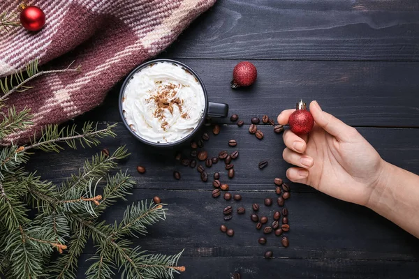 Woman Holding Christmas Ball Cup Tasty Coffee Cinnamon Black Wooden — Stock Photo, Image