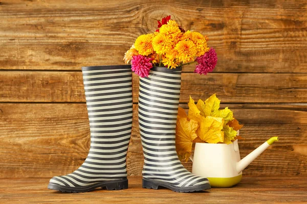 Rubber Boots Watering Can Autumn Leaves Flowers Wooden Background — Stock Photo, Image