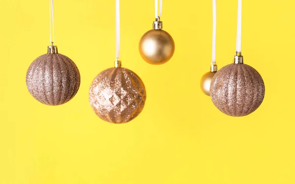 Golden Christmas Balls Yellow Background Closeup — Stock Photo, Image