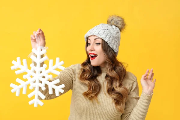 Surprised Beautiful Woman Holding Big Snowflake Yellow Background — Stock Photo, Image
