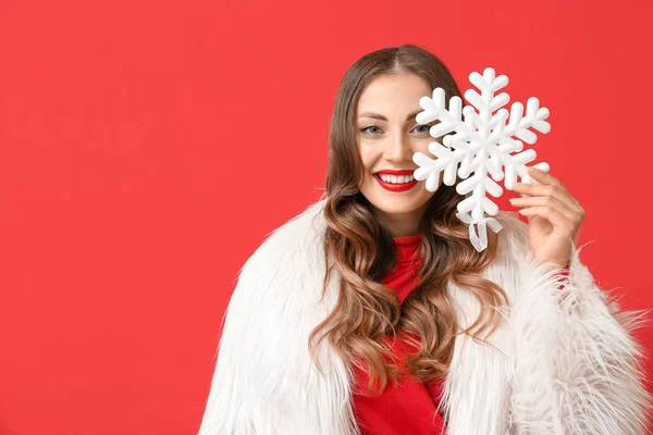 Fashionable Smiling Woman Holding Big Snowflake Face Red Background — Stock Photo, Image