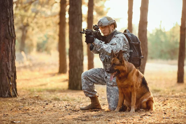 Soldier with military working dog during combat operation outdoors