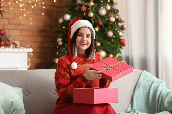 Beautiful Young Woman Opening Gift Home Christmas Eve — Stock Photo, Image