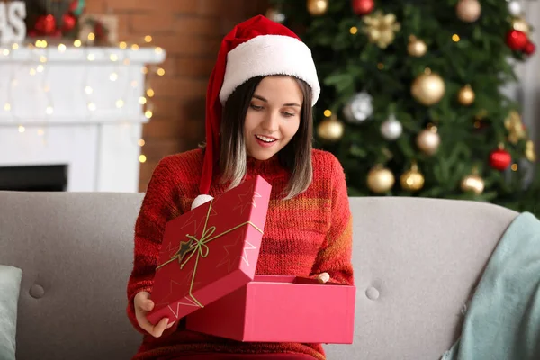 Beautiful Young Woman Opening Gift Home Christmas Eve — Stock Photo, Image