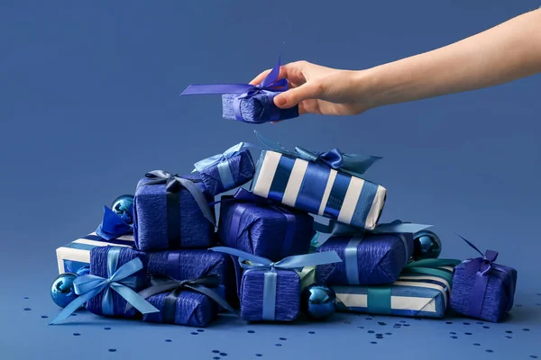 Female Hand Many Christmas Gift Boxes Blue Background — Stock Photo, Image